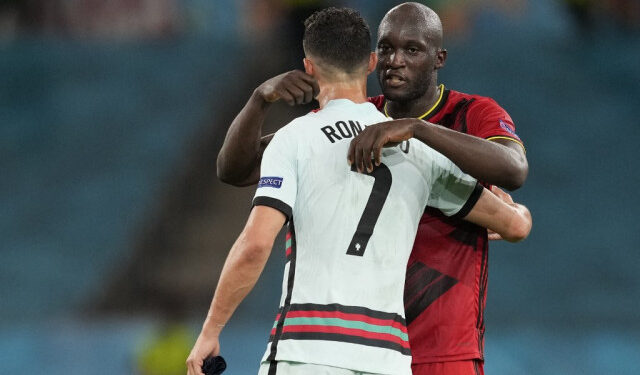 Belgium's forward Romelu Lukaku (R) embraces Portugal's forward Cristiano Ronaldo at the end of the UEFA EURO 2020 round of 16 football match between Belgium and Portugal at La Cartuja Stadium in Seville on June 27, 2021. (Photo by THANASSIS STAVRAKIS / POOL / AFP)