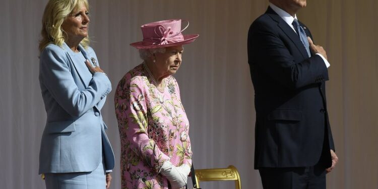 Britain's Queen Elizabeth II stands with US President Joe Biden and First Lady Jill Biden as they listen to the US national anthem at Windsor Castle near London, Sunday, June 13, 2021. (AP Photo/Alberto Pezzali)