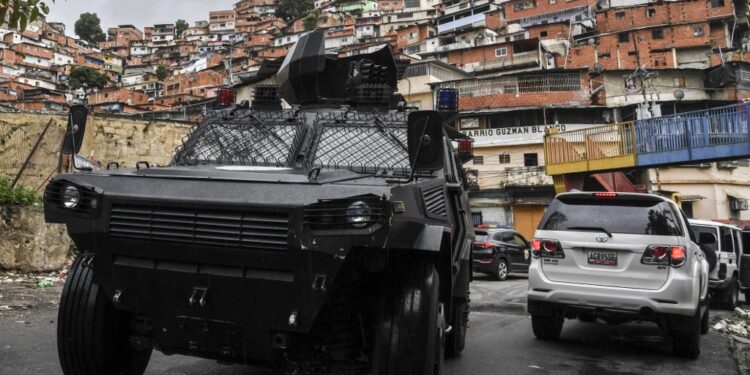 (FILES) In this file photo taken on July 09, 2021 A VN-4 armored vehicle of a special unit of the national police drives along one of the main streets of the Cota 905 neighborhood after three days of clashes with alleged members of a criminal gang, in Caracas on July 9, 2021. - Confrontations between criminal gangs and authority forces have made poor neighborhoods in Venezuela become a hail of bullets. (Photo by Yuri CORTEZ / AFP)