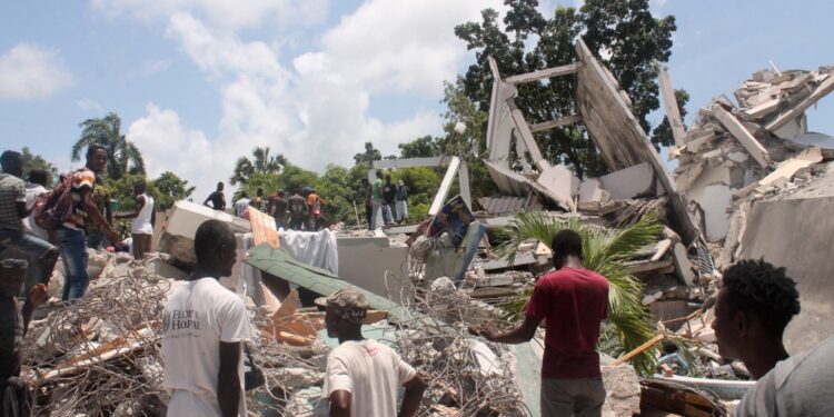 People search through the rubble of what used to be the Manguier Hotel after the earthquake hit on August 14, 2021 in Les Cayes, southwest Haiti. - Rescue workers scrambled to find survivors after a powerful 7.2-magnitude earthquake struck Haiti early Saturday, killing at least 304 and toppling buildings in the disaster-plagued Caribbean nation still recovering from a devastating 2010 quake.
The epicenter of the shaking, which rattled homes and sent terrified locals scrambling for safety, was about 100 miles (160 kilometers) by road west of the center of the densely populated capital Port-au-Prince. (Photo by Stanley LOUIS / AFP)