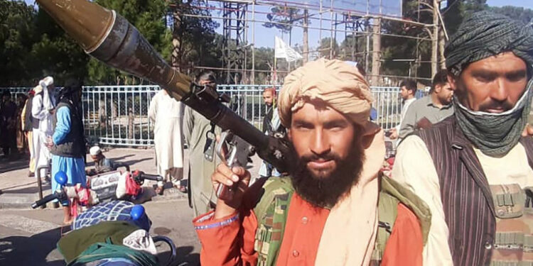 In this picture taken on August 13, 2021, a Taliban fighter holds a rocket-propelled grenade (RPG) along the roadside in Herat, Afghanistan's third biggest city, after government forces pulled out the day before following weeks of being under siege. (Photo by - / AFP)