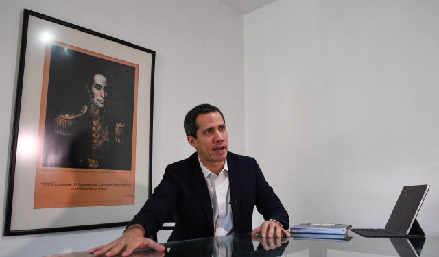Venezuelan opposition leader Juan Guaido gestures as he speaks during an interview with the AFP at his home in Caracas on August 25, 2021. (Photo by Federico PARRA / AFP)