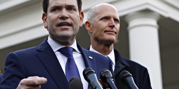 Sen. Marco Rubio, R-Fla., left, with Sen. Rick Scott, R-Fla., speaks to the media after their meeting with President Donald Trump about Venezuela, Tuesday, Jan. 22, 2019, at the White House in Washington. (AP Photo/Jacquelyn Martin)