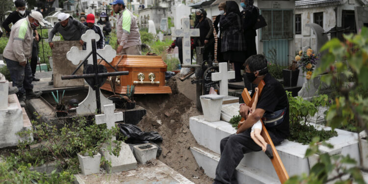 Cemetery workers move the coffin of a man, who died of the coronavirus disease (COVID-19), during his funeral at the San Nicolas Tolentino cemetery as the coronavirus disease (COVID-19) outbreak continues, in the Iztapalapa neighbourhood in Mexico City, Mexico, August 4, 2020. REUTERS/Henry Romero