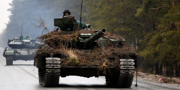 TOPSHOT - Ukrainian tanks move on a road before an attack in Lugansk region on February 26, 2022. - Russia on February 26 ordered its troops to advance in Ukraine "from all directions" as the Ukrainian capital Kyiv imposed a blanket curfew and officials reported 198 civilian deaths. (Photo by Anatolii Stepanov / AFP) (Photo by ANATOLII STEPANOV/AFP via Getty Images)