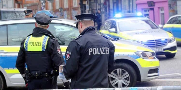 13 December 2019, Hamburg: Police forces are standing at a closed road on St. Pauli. The car of Hamburg Senator of the Interior Andy Grote was thrown with stones and paint containers in the morning. According to the police, the politician was sitting in his car on the way to the office during the attack. When the Minister of the Interior's car had to stop at an intersection in the St. Pauli district, masked people approached the vehicle and attacked it. The State Criminal Police Office has started the investigation. Photo: Bodo Marks/dpa