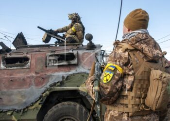 Soldados ucranianos inspeccionan el domingo 27 de febrero de 2022 un vehículo militar dañado tras combates en Járkiv, Ucrania. (AP Foto/Marienko Andrew)