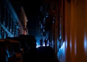 People are seen walking in a street left in darkness by a power outage due to a cyberattack in Old San Juan, Puerto Rico, June 10, 2021. - A fire at an electrical substation in Puerto Rico left thousands of customers in the dark June 10, shortly after the power company reported a cyberattack that it did not immediately link to the blaze. 
"There was a fire in a transformer at the Monacillo substation" in San Juan, Luma Energy said, two hours after it said it was the target of a DDoS, or denial of service, attack with two million visits per second. (Photo by Ricardo ARDUENGO / AFP) (Photo by RICARDO ARDUENGO/AFP via Getty Images)