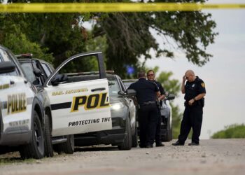 Police protect the scene where officials say dozens of people have been found dead and multiple others were taken to hospitals with heat-related illnesses after a semitrailer containing suspected migrants was found, Tuesday, June 28, 2022, in San Antonio. (AP Photo/Eric Gay)