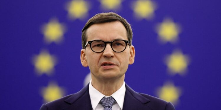 (FILES) In this file photo taken on October 19, 2021 Polish Prime Minister Mateusz Morawiecki delivers a speech during a debate on The Rule of law crisis in Poland and the primacy of EU law at the European Parliament in Strasbourg. - Poland's prime minister accused the EU of putting a "gun to our head" by demanding his country reverse judicial reforms while threatening sanctions, in an interview published in the Financial Times on October 25, 2021. (Photo by RONALD WITTEK / POOL / AFP)