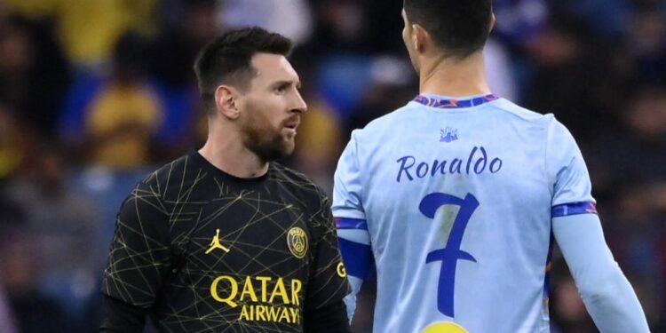 Paris Saint-Germain's Argentine forward Lionel Messi (L) walks past Riyadh All-Star's Portuguese forward Cristiano Ronaldo (R) during the Riyadh Season Cup football match between the Riyadh All-Stars and Paris Saint-Germain at the King Fahd Stadium in Riyadh on January 19, 2023. (Photo by FRANCK FIFE / AFP)