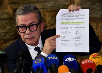 Gerardo Blyde Perez, head of the Venezuelan opposition's delegation, shows a document signed during the negotiations in Mexico in a news conference in Caracas, Venezuela January 20, 2023. REUTERS/Gaby Oraa