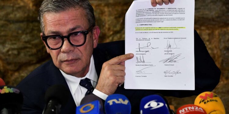 Gerardo Blyde Perez, head of the Venezuelan opposition's delegation, shows a document signed during the negotiations in Mexico in a news conference in Caracas, Venezuela January 20, 2023. REUTERS/Gaby Oraa