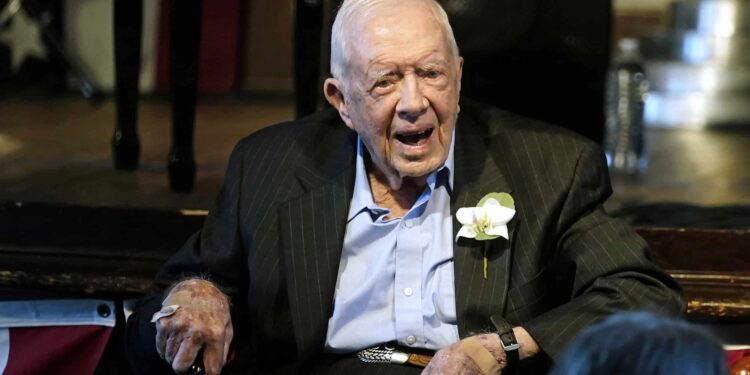 FILE - Former President Jimmy Carter reacts as his wife Rosalynn Carter speaks during a reception to celebrate their 75th wedding anniversary, July 10, 2021, in Plains, Ga. The Carter Center said Saturday, Feb. 18, 2023, that former President Jimmy Carter has entered home hospice care. The charity created by the 98-year-old former president said on Twitter that after a series of short hospital stays, Carter “decided to spend his remaining time at home with his family and receive hospice care instead of additional medical intervention." (AP Photo/John Bazemore, Pool, File)