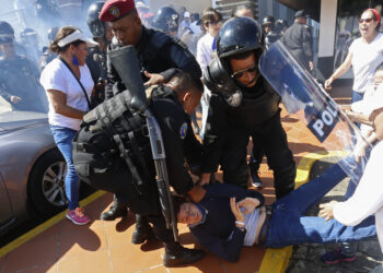 An anti-government protester is dragged away and arrested by police as security forces disrupt an opposition march coined "United for Freedom" in Managua, Nicaragua, Sunday, Oct. 14, 2018. Anti-government protests calling for President Daniel Ortega's resignation are ongoing since April, triggered by a since-rescinded government plan to cut social security pensions. Ortega said opponents will have to wait until his term ends in 2021. (AP Photo/Alfredo Zuniga)