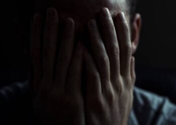 Portrait of a man in dark room. Depression concept.