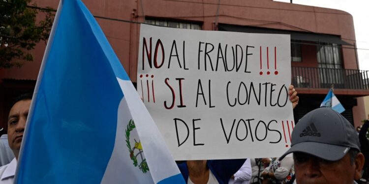 People protest outside the Supreme Electoral Tribunal demanding a repeat of the elections in the face of alleged electoral fraud in Guatemala City on July 2, 2023. Guatemalans were on tenterhooks on Sunday after the country's highest court ordered a halt to the vote count until complaints of alleged irregularities by right-wing forces are resolved, a move criticized by local and foreign entities and raising the possibility of annulling the June 25 elections. (Photo by Johan ORDONEZ / AFP)