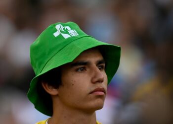 A pilgrim wearing a JMJ (WYD) hat attends the opening mass of the World Youth Day (WYD) gathering of young Catholics in Eduardo VII Park in Lisbon on August 1, 2023. Portugal is expecting about a million pilgrims from around the world, according to organisers, to attend the World Youth Day gathering of young Catholics from August 1 to 6. Originally scheduled for August 2022, the event was postponed because of the Covid-19 pandemic. (Photo by Patricia DE MELO MOREIRA / AFP)