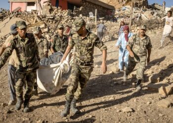 Moroccan Royal Armed Forces evacuate a body from a house destroyed in an earthquake in the mountain village of Tafeghaghte, southwest of the city of Marrakesh, on September 9, 2023. Morocco's deadliest earthquake in decades has killed more than 1,300 people, authorities said on September 9, as troops and emergency services scrambled to reach remote mountain villages where casualties are still feared trapped. (Photo by FADEL SENNA / AFP)