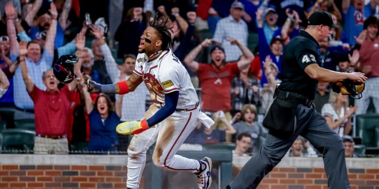 Atlanta (United States), 27/09/2023.- Atlanta Braves right fielder Ronald Acuna Jr. (L) reacts after scoring the game-winning run against the Chicago Cubs as home plate umpire Shane Livensparger (R) reacts during the tenth inning of an MLB baseball game between the Chicago Cubs and the Atlanta Braves at Truist Park in Atlanta, Georgia, USA, 27 September 2023. EFE/EPA/ERIK S. LESSER