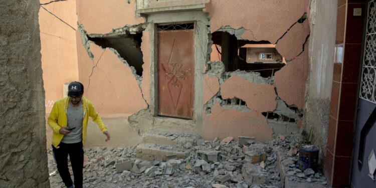 Marrakesh (Morocco), 09/09/2023.- A person walks over debris next to a damaged building following an earthquake in Marrakesh, Morocco, 09 September 2023. A powerful earthquake that hit central Morocco late 08 September, killed at least 820 people and injured 672 others, according to a provisional report from the country's Interior Ministry. The earthquake, measuring magnitude 6.8 according to the USGS, damaged buildings from villages and towns in the Atlas Mountains to Marrakesh. (Terremoto/sismo, Marruecos) EFE/EPA/JALAL MORCHIDI