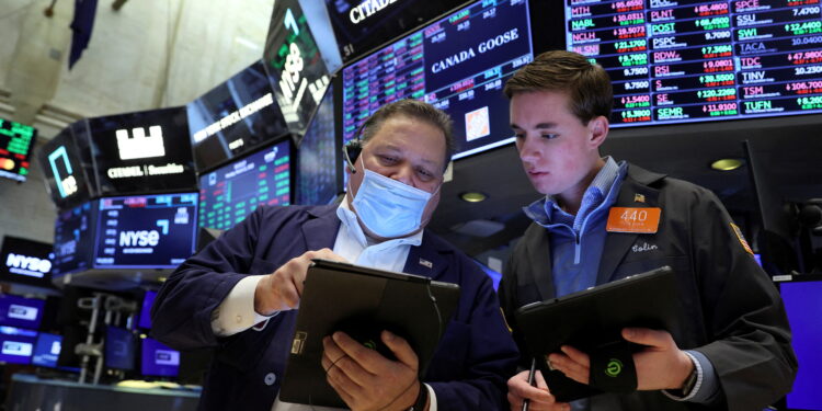 FILE PHOTO: Traders work on the floor of the New York Stock Exchange (NYSE) in New York City, U.S., March 21, 2022.  REUTERS/Brendan McDermid