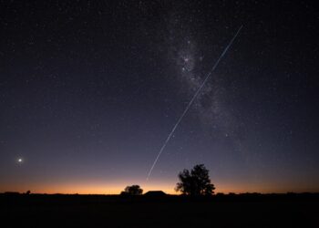 This long-exposure image shows a trail of a group of SpaceX's Starlink G6-27 satellites passing over Uruguay, with part of the Milky Way and planet Venus (L) in the frame, as seen from the countryside some 185 km north of Montevideo near Capilla del Sauce, Florida Department, at twilight early on November 12, 2023. (Photo by Mariana SUAREZ / AFP)
