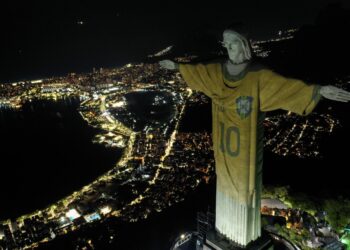 Aerial view showing an image projected onto the Christ the Redeemer statue pays tribute to Brazilian football legend Pele on the first anniversary of his death, at Corcovado Mount in Rio de Janeiro, Brazil, on December 29, 2023. (Photo by Mauro PIMENTEL / AFP)