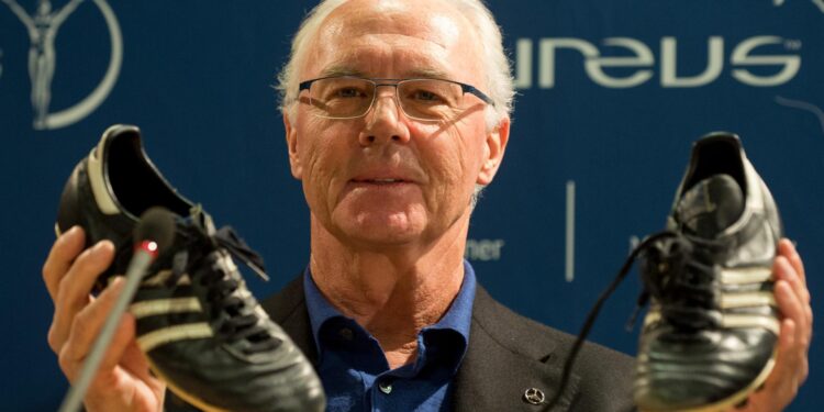 Stuttgart (Germany), 27/01/2013.- (FILE) - A file photograph of former German soccer player and coach, Franz Beckenbauer, holding up soccer trainers during a press conference in Stuttgart, Germany, 27 January 2013, re-issued 08 January 2024. Beckenbauer passed away on 07 January 2024 aged 78, as his family confirmed on 08 January. (Alemania) EFE/EPA/MARIJAN MURAT GERMANY OUT *** Local Caption *** 50685298