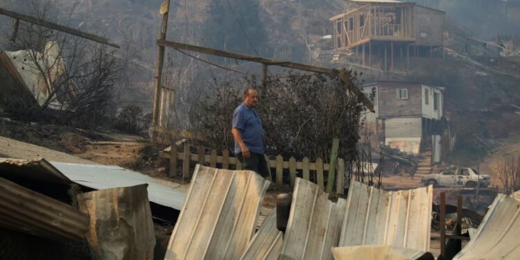 Un hombre cerca de los restos de casas quemadas tras la propagación de los incendios forestales en Viña del Mar. (REUTERS/Sofia Yanjari)REUTERS