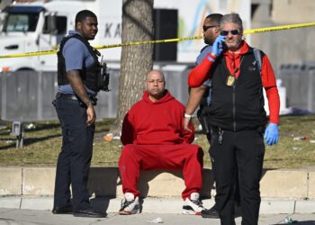 A person is detained by police near the Kansas City Chiefs' Super Bowl LVIII victory parade on February 14, 2024, in Kansas City, Missouri. Shots were reportedly fired during the parade, according to police. (Photo by ANDREW CABALLERO-REYNOLDS / AFP)