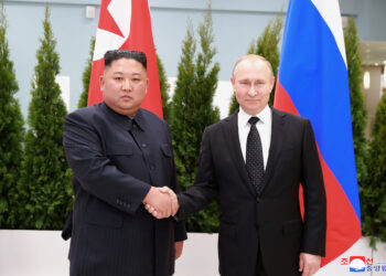 FILE PHOTO: North Korean leader Kim Jong Un shakes hands with Russian President Vladimir Putin in Vladivostok, Russia in this undated photo released on April 25, 2019 by North Korea's Central News Agency (KCNA). KCNA via REUTERS