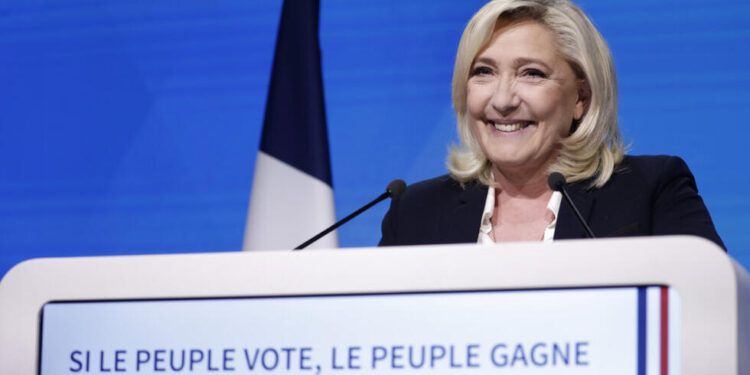 French far-right candidate Marine Le Pen delivers a speech at her election day headquarters in Paris, Sunday, April 10, 2022. French polling agency projections show incumbent French President Emmanuel Macron and far-right leader Marine Le Pen leading in the first round of France's presidential election Sunday. (AP Photo/Lewis Joly)