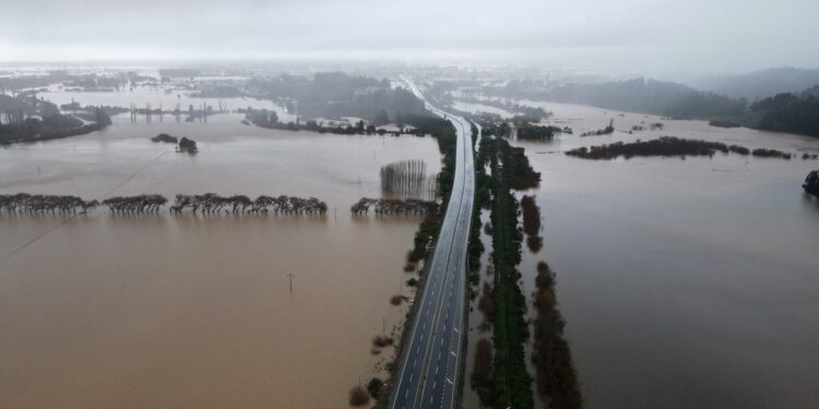 Aerial view of the Pichilo River after heavy rains in Arauco, Biobio region, Chile, taken on June 13, 2024. Heavy rains battered south and central Chile on Thursday, killing one person and causing damage to hundreds of homes as authorities declared a state of catastrophe in five regions of the South American country. (Photo by GUILLERMO SALGADO / AFP)