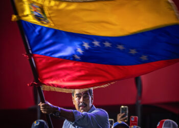 AME4896. CARACAS (VENEZUELA), 25/07/2024.- El presidente de Venezuela y aspirante a la reelección, Nicolás Maduro, agita una bandera en el cierre de su campaña este jueves, en Caracas (Venezuela). Maduro aseguró que cuenta con una "nueva mayoría" que lo respaldará en los comicios de este domingo, en los que buscará una segunda reelección, para lo que deberá enfrentarse contra nueve contendientes. EFE/ Henry Chirinos