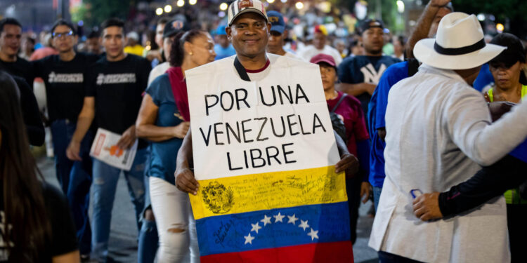 AME9417. CARACAS (VENEZUELA), 04/07/2024.- Un hombre participa en un acto de campaña del candidato opositor Edmundo González este jueves, en Caracas (Venezuela). Comienza oficialmente la campaña electoral para las presidenciales del 28 de julio, en las que se medirán diez candidatos, entre ellos el actual presidente, Nicolás Maduro, y el abanderado de la mayor coalición opositora -la Plataforma Unitaria Democrática (PUD)-, Edmundo González Urrutia, quienes ya llevan semanas de precampaña con actos proselitistas por diversos estados del país. EFE/ Ronald Peña R.