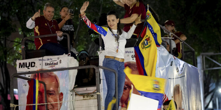 AME9387. CARACAS (VENEZUELA), 04/07/2024.- La líder opositora María Corina Machado (d) saluda durante un acto de campaña del Candidato opositor Edmundo González (i) este jueves, en Caracas (Venezuela). Comienza oficialmente la campaña electoral para las presidenciales del 28 de julio, en las que se medirán diez candidatos, entre ellos el actual presidente, Nicolás Maduro, y el abanderado de la mayor coalición opositora -la Plataforma Unitaria Democrática (PUD)-, Edmundo González Urrutia, quienes ya llevan semanas de precampaña con actos proselitistas por diversos estados del país. EFE/ Ronald Peña R.