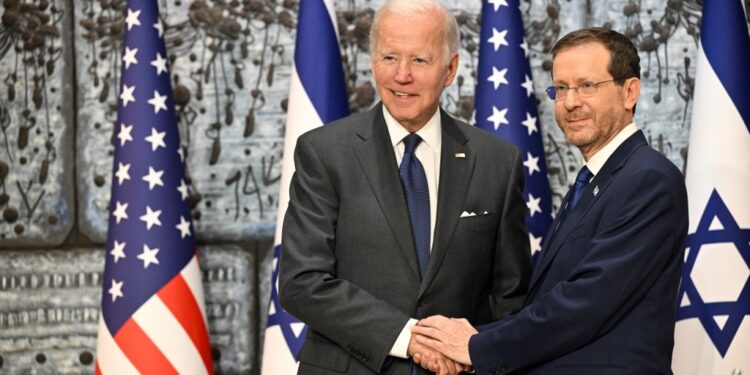 US President Joe Biden shakes hands with President Isaac Herzog (R) at the President's Residence in Jerusalem on July 14, 2022. (MANDEL NGANAFP)