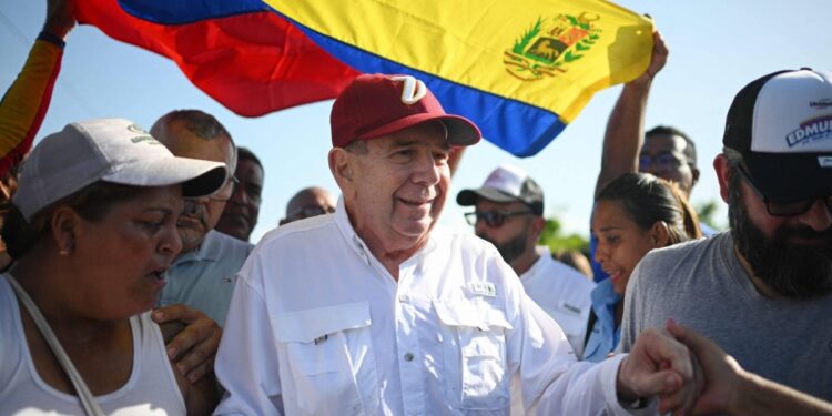 (FILES) The Venezuelan opposition presidential candidate for the Plataforma Unitaria Democratica party, Edmundo Gonzalez Urrutia (C), greets supporters upon his arrival at the campaign act in Barlovento Town in Miranda State, Venezuela, on June 26, 2024. Edmundo González Urrutia, Nicolás Maduro's rival in his questioned reelection, asked the attorney general on Wednesday to avoid a political persecution, when he is required by a justice system pointed out by the opposition of serving Chavism. (Photo by Federico PARRA / AFP)