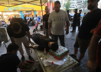 A man donates blood under a tent in Beirut's southern suburb on September 17, 2024, after explosions hit locations in several Hezbollah strongholds around Lebanon amid ongoing cross-border tensions between Israel and Hezbollah fighters. - Hundreds of pagers used by Hezbollah members exploded across Lebanon Tuesday, killing at least eight people and wounding Tehran's ambassador in Beirut in blasts the Iran-backed militant group blamed on Israel. (Photo by AFP)