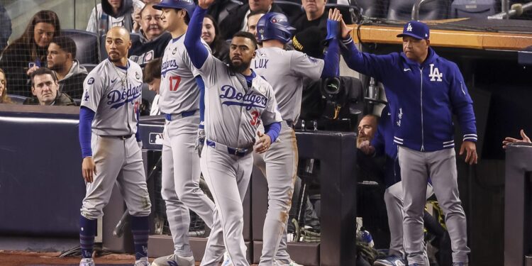 New York (United States), 28/10/2024.- The Dodgers dugout celebrates an RBI single by teammate Enrique Hernandez during the sixth inning of game three of the Major League Baseball (MLB) World Series between the American League Champion New York Yankees and the National League Champion Los Angeles Dodgers at Yankees Stadium in the Bronx borough of New York, New York, USA, 28 October 2024. The World Series is the best-of-seven games. (Nueva York) EFE/EPA/SARAH YENESEL