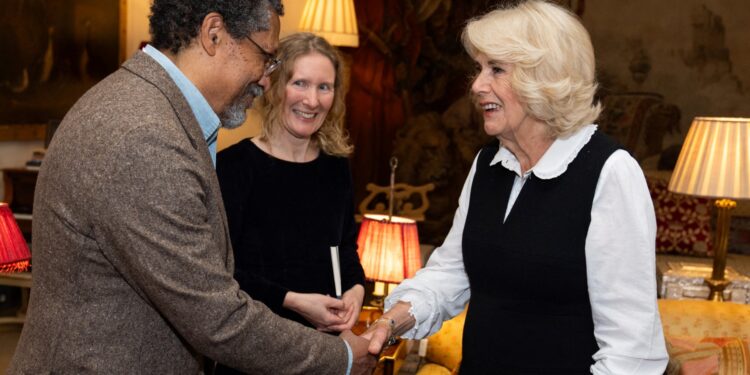 Britain's Queen Camilla (R) shakes hands with US writer Percival Everett during a reception for the Booker Prize Foundation at Clarence House, in London, on November 12, 2024 ahead of the Booker Prize 2024 ceremony. The winner of the Booker Prize is to be announced on November 12, 2024 with a record five female authors vying to win the prestigious English-language literary award. Six authors from five countries have been shortlisted, with the winner of the £50,000 ($64,500) prize to be announced at a glitzy ceremony in London. (Photo by Aaron Chown / POOL / AFP)