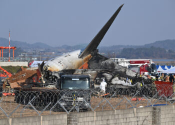 Firefighters and rescue personnel work near the wreckage of a Jeju Air Boeing 737-800 series aircraft after the plane crashed and burst into flames at Muan International Airport in South Jeolla Province, some 288 kilometres southwest of Seoul on December 29, 2024. - A Jeju Air plane carrying 181 people from Bangkok to South Korea crashed on arrival December 29, colliding with a barrier and bursting into flames, with only two survivors rescued so far and 120 confirmed dead. (Photo by JUNG YEON-JE / AFP)