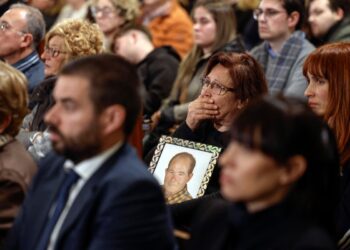 A woman holds the photograph of a victim during a funeral mass held on December 9, 2024 at the Cathedral of Valencia in memory of the victims of the deadly floods that devastaded the region in late October. - According to authorities, 230 people died during the floods on October 29, 222 of them in the Valencian region, while four others are still missing. (Photo by Kai FOSTERLING / POOL / AFP)