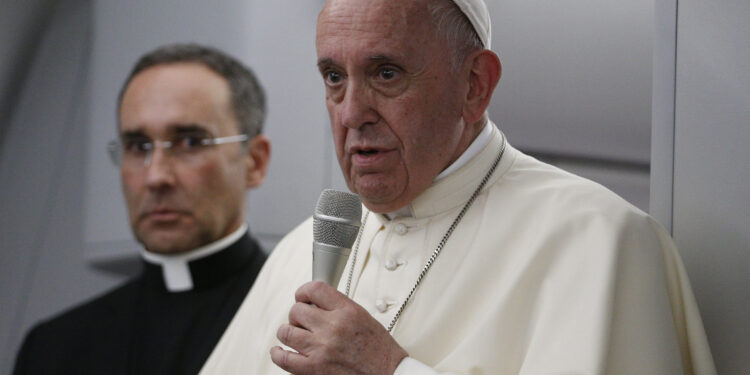 Pope Francis answers questions from journalists aboard his flight from Panama City to Rome, Jan. 27, 2019. Also pictured is Msgr. Mauricio Rueda, papal trip planner. (CNS photo/Paul Haring) See POPE-PANAMA-PRESSER Jan. 28, 2019.